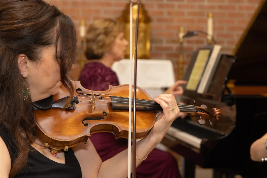 A violinist's hand and bow mid-phrase