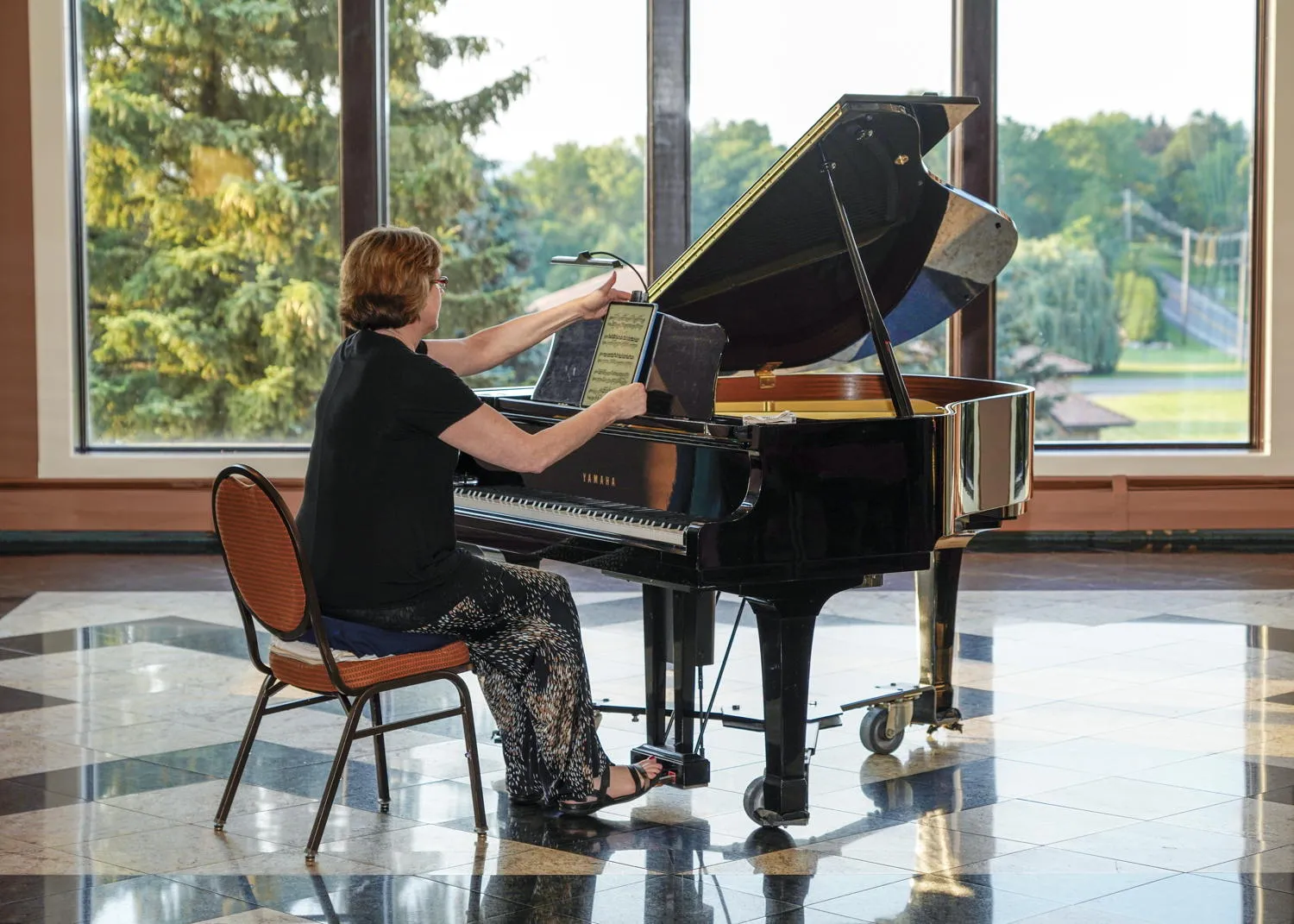 A pianist playing by the windows