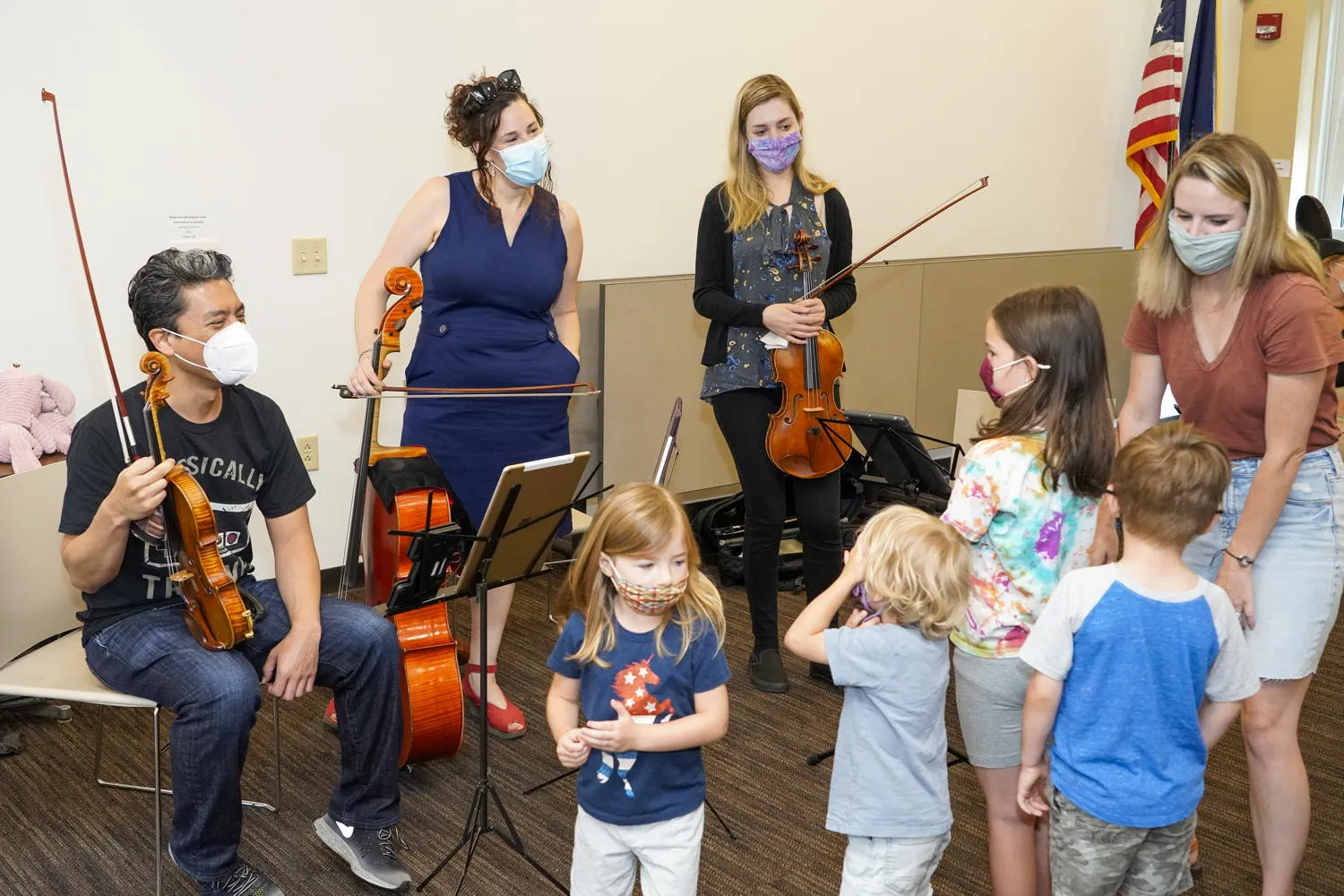 Children gathered around the string players