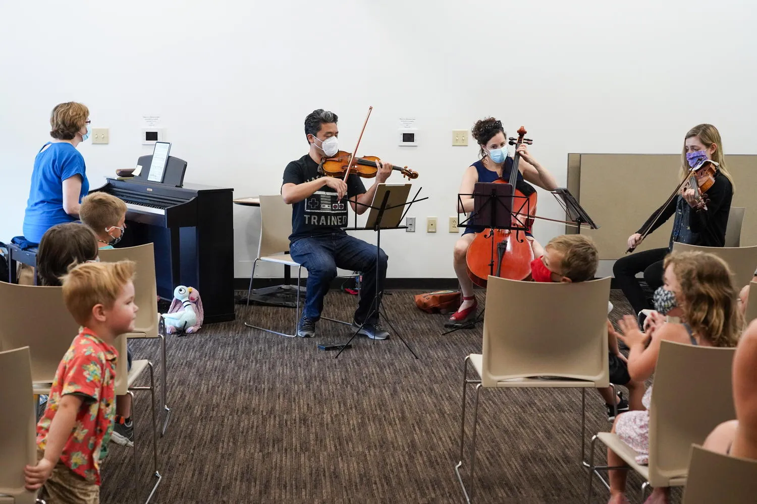 Musicians playing for young listeners