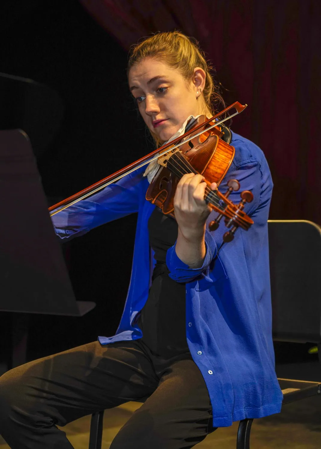 A violinist in a blue jacket