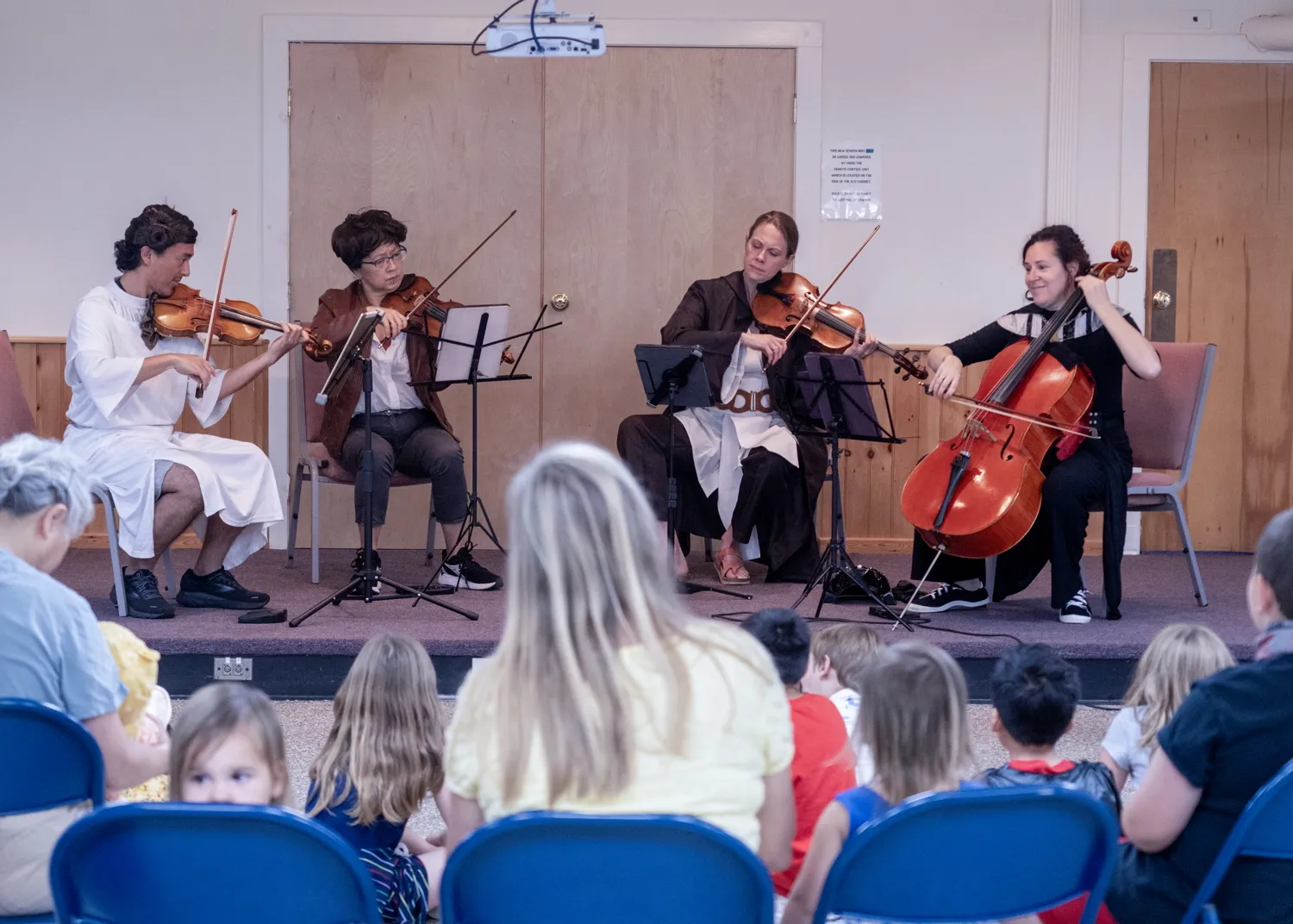 A string quartet in Star Wars costumes playing for children