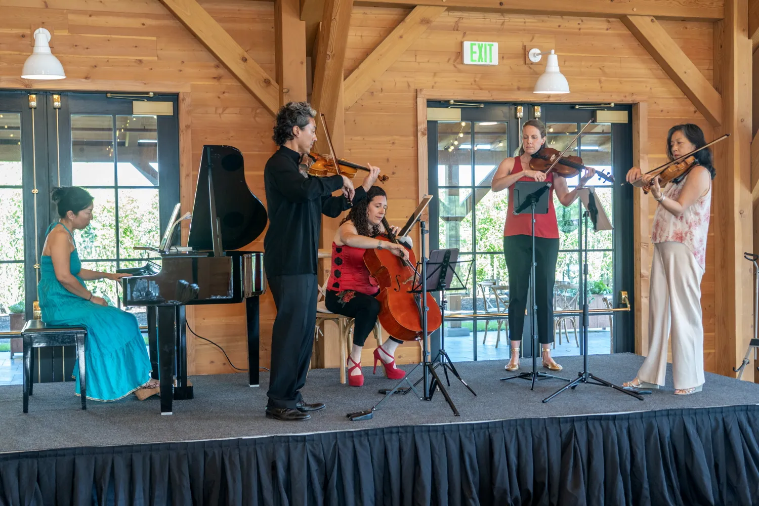 Piano and strings on the stage at The Lake House