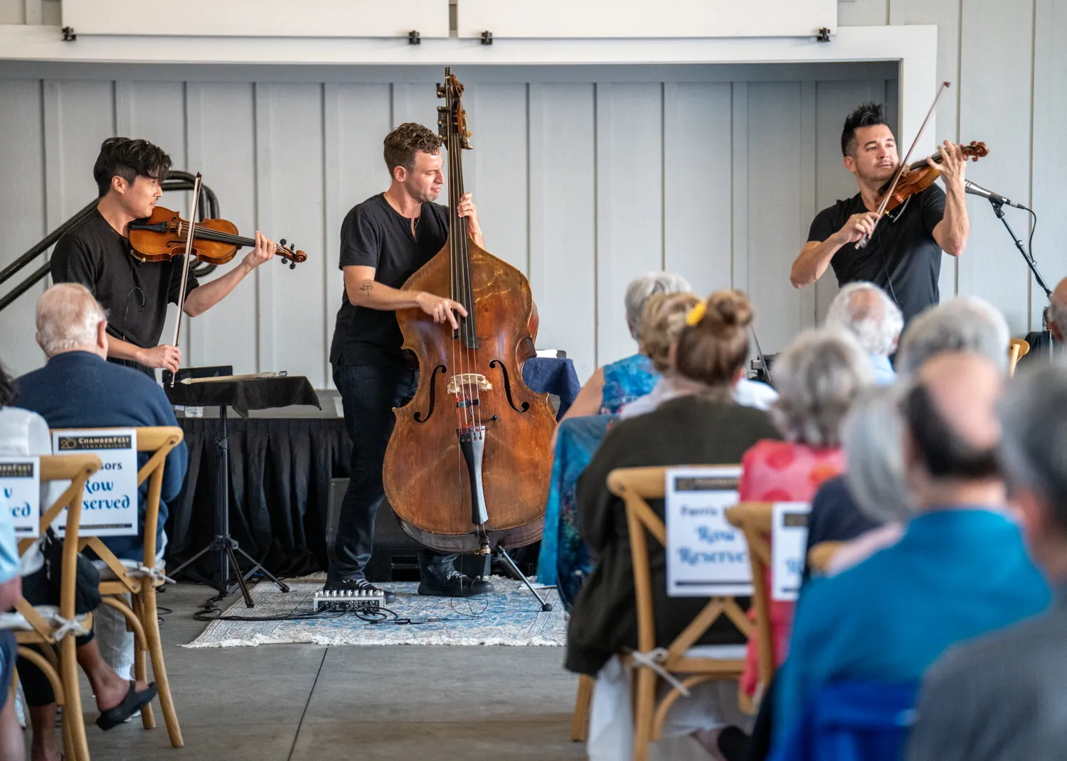 Time for Three playing for seated guests at the Fallbrook House