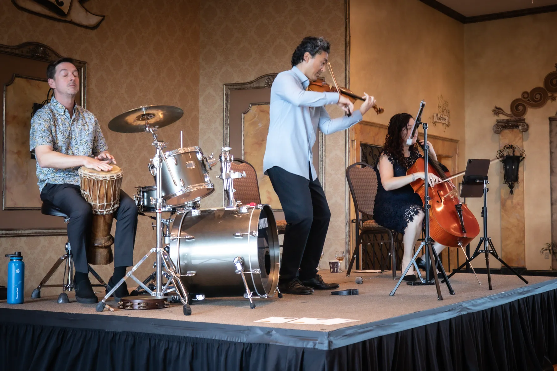 Percussion, violin and cello playing on the stage at Ventosa