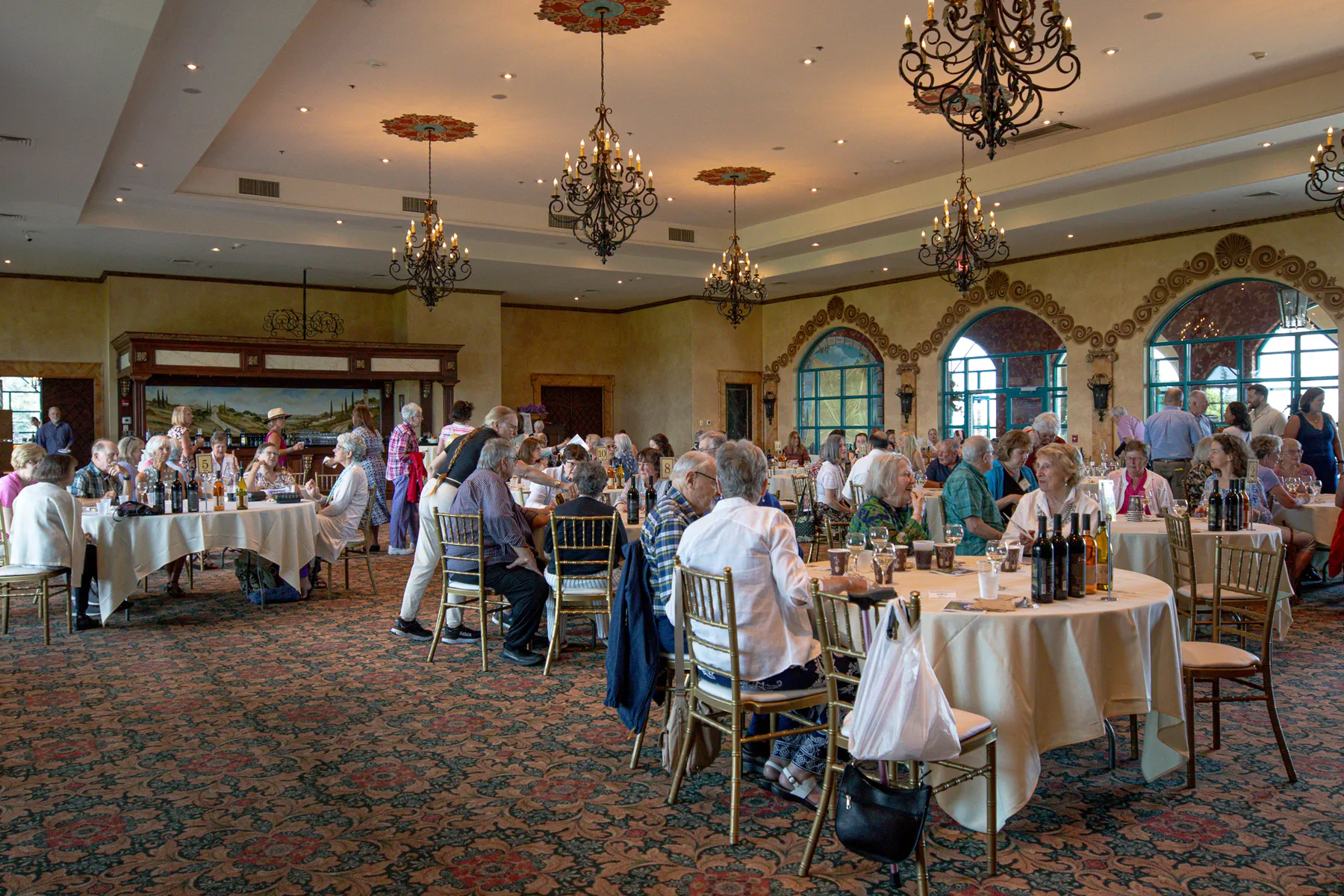 Guests at tables set with wine bottles in the Ventosa hall