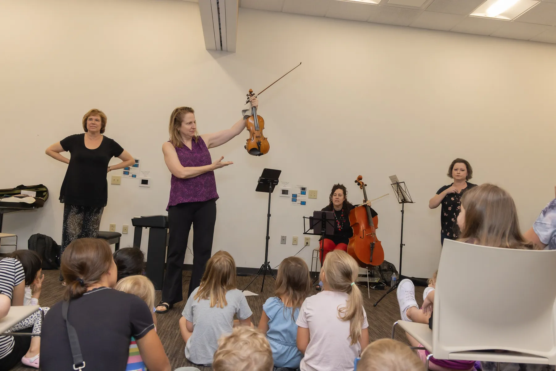 Children listening to the string players