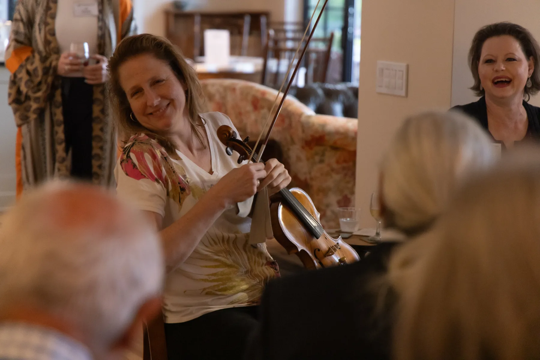 A violinist reading at the party